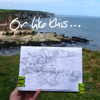Or like this - sketchbook with pencil sketch held in front of a view of the coast stretching away