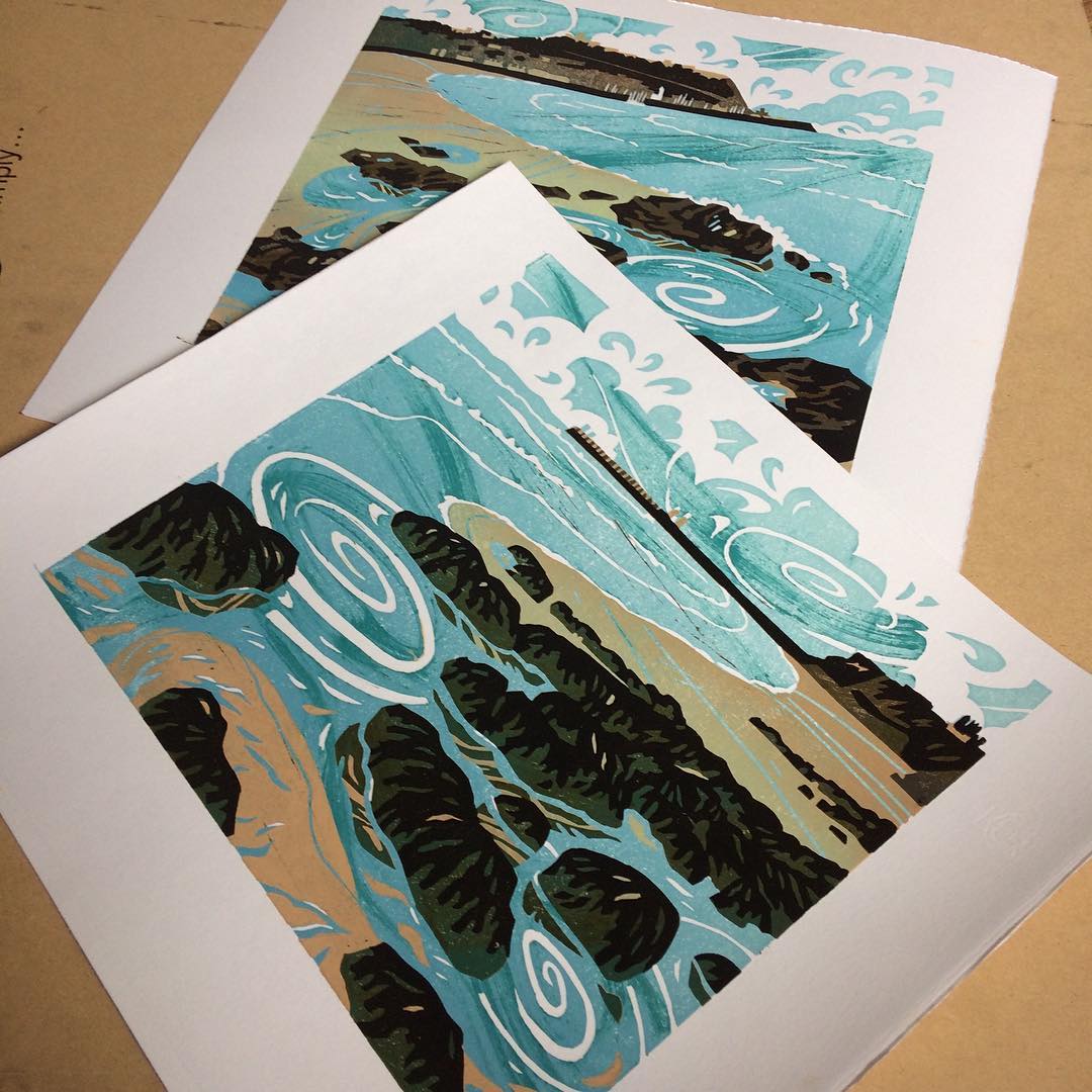 Two unframed prints lie together showing their colour scheme is the same